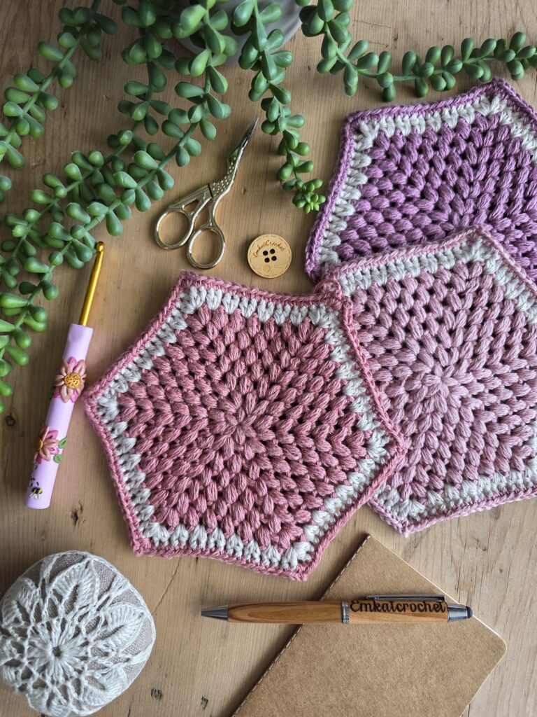 Yarnsmiths Summer Meadow range in all available colours, neatly arranged in a wicker basket on a wooden table, with a leafy green plant beside it, from Wool Warehouse