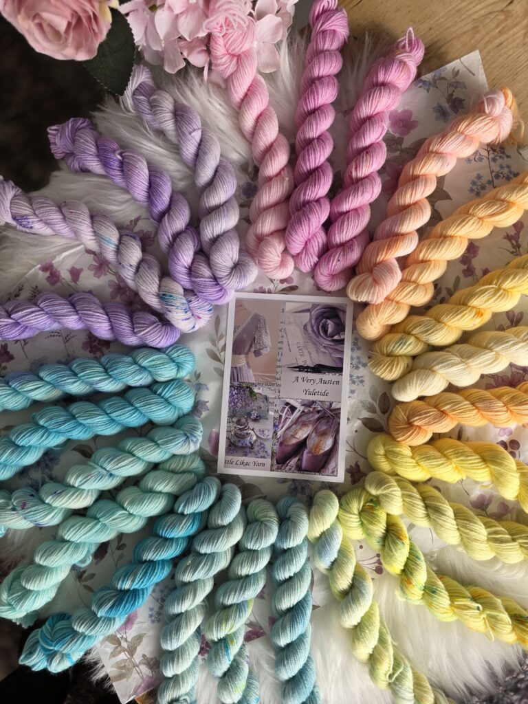 Mini skein yarn advent in pastel and bright shades laid out together, used for a crochet shawl project.